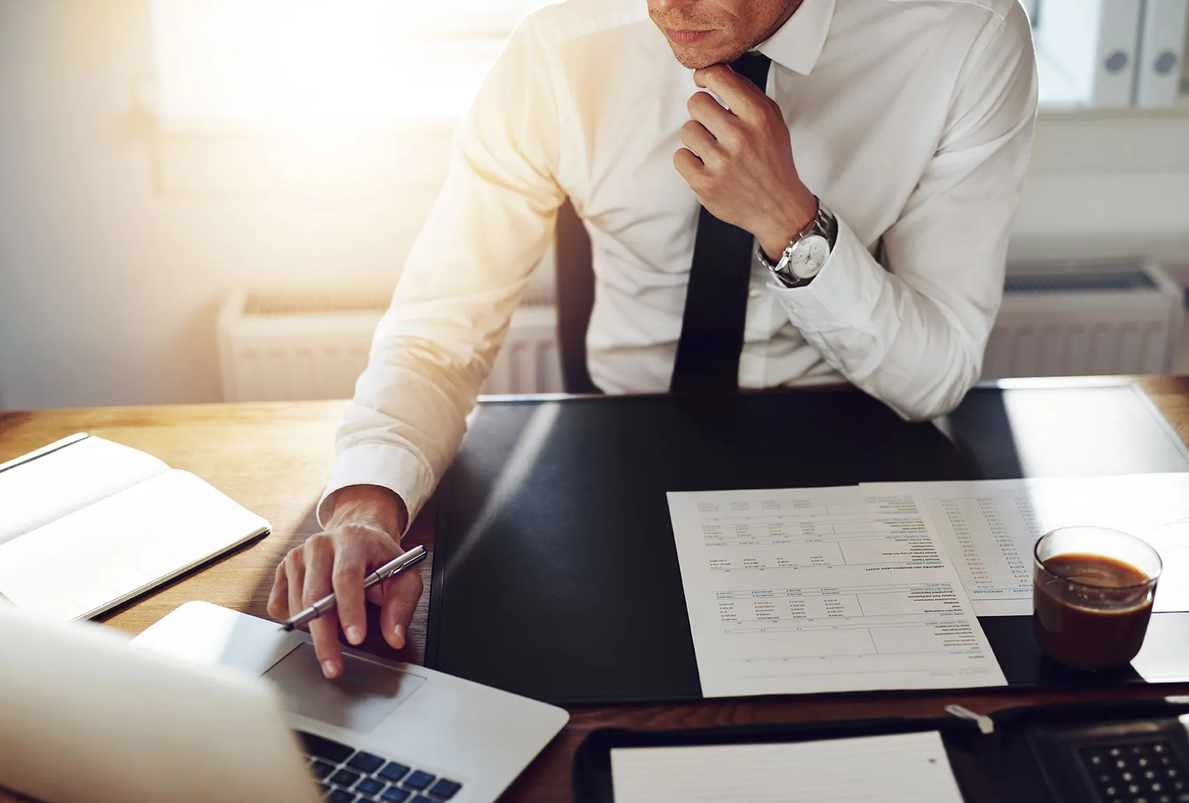 Consultant reviewing project plans at a desk